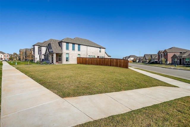 16900 Sophora Ave, Justin, TX 76247 - view of side of home with a yard, a residential view, and fence