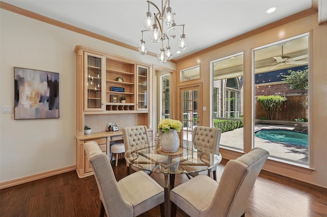 dining area with ceiling fan with notable chandelier, baseboards, dark wood-style floors, and ornamental molding