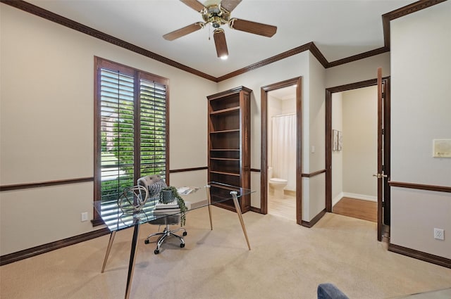 office space with a ceiling fan, baseboards, light colored carpet, and crown molding