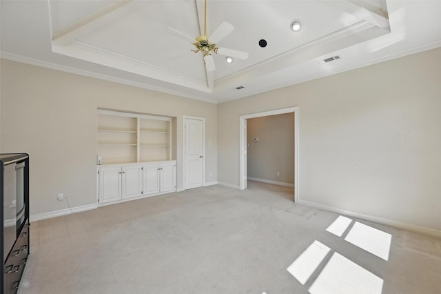 unfurnished bedroom featuring crown molding, light carpet, a raised ceiling, baseboards, and visible vents