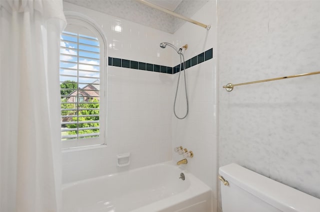 full bathroom featuring shower / bath combo with shower curtain and toilet