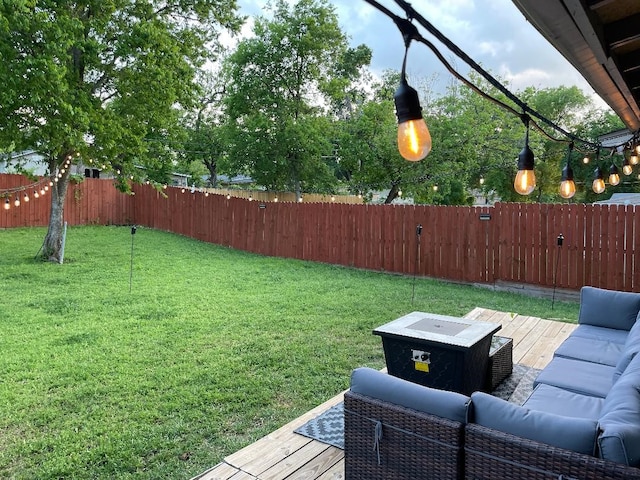view of yard with a deck, an outdoor living space, and a fenced backyard