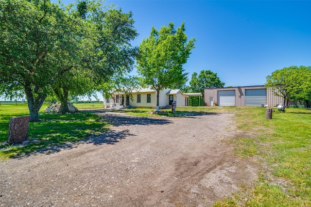 14357 Fm 1392, Terrell, TX 75160 - view of front facade featuring a front lawn, driveway, an outbuilding, and a garage