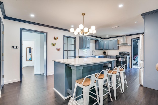 14357 Fm 1392, Terrell, TX 75160 - kitchen featuring wall chimney exhaust hood, electric range, an inviting chandelier, light countertops, and a kitchen island