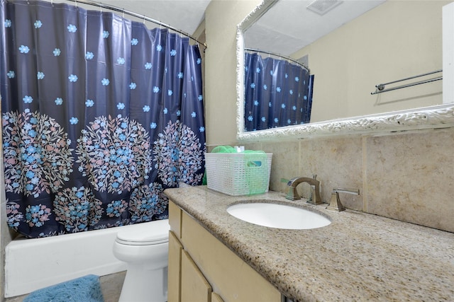 bathroom featuring decorative backsplash, toilet, vanity, and visible vents
