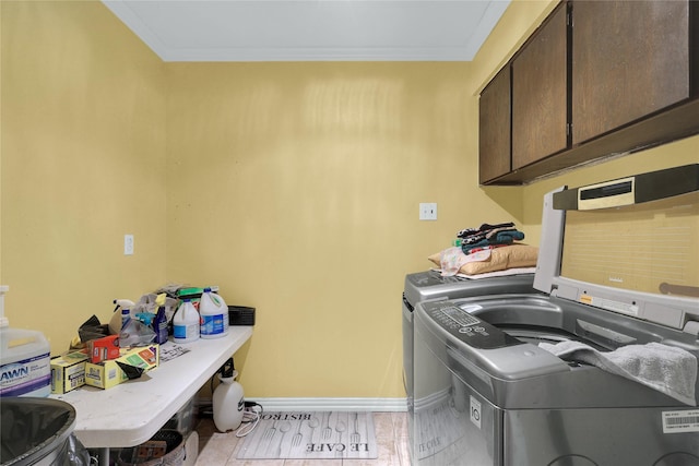 laundry room with ornamental molding, baseboards, cabinet space, and independent washer and dryer