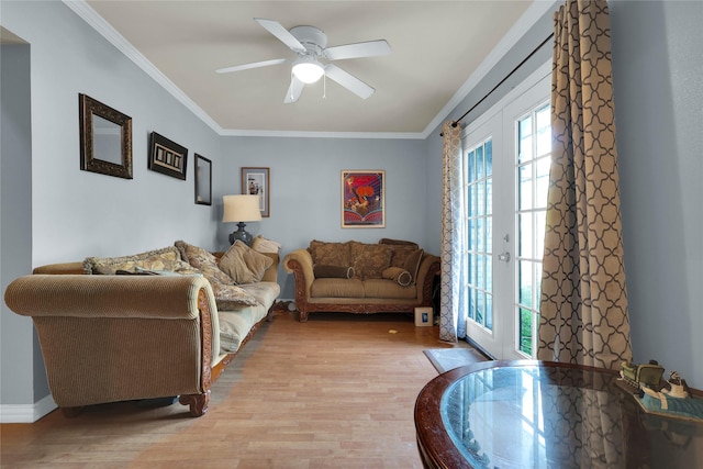 living room with a ceiling fan, ornamental molding, french doors, and light wood-style flooring