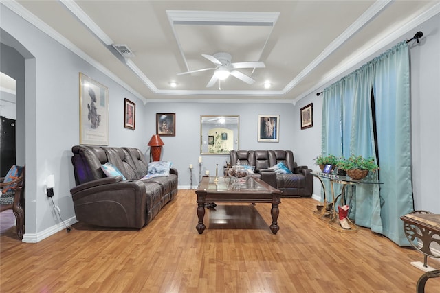 living room with a ceiling fan, light wood-type flooring, arched walkways, baseboards, and visible vents