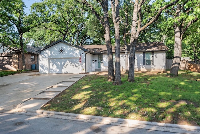ranch-style house featuring driveway, fence, brick siding, an attached garage, and a front yard