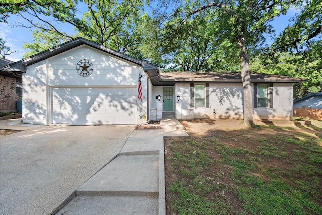 single story home featuring an attached garage and concrete driveway