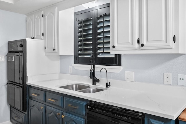 kitchen with black appliances, blue cabinetry, a sink, and white cabinets