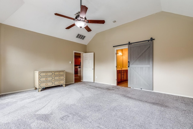 10625 Sexton Dr, Mckinney, TX 75072 - unfurnished bedroom with vaulted ceiling, carpet flooring, a barn door, ceiling fan, and ensuite bathroom