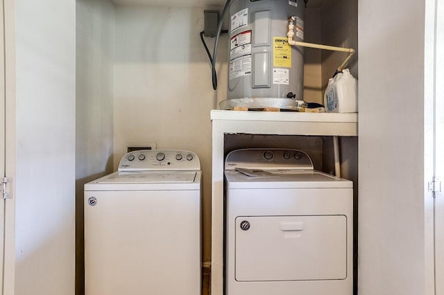 washroom featuring washing machine and clothes dryer and water heater