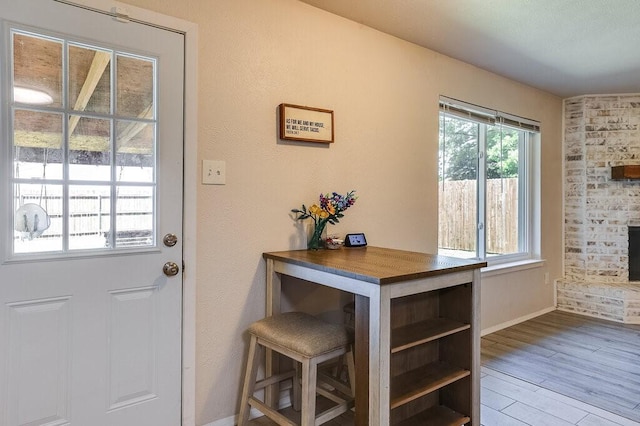 entryway with wood finished floors and baseboards