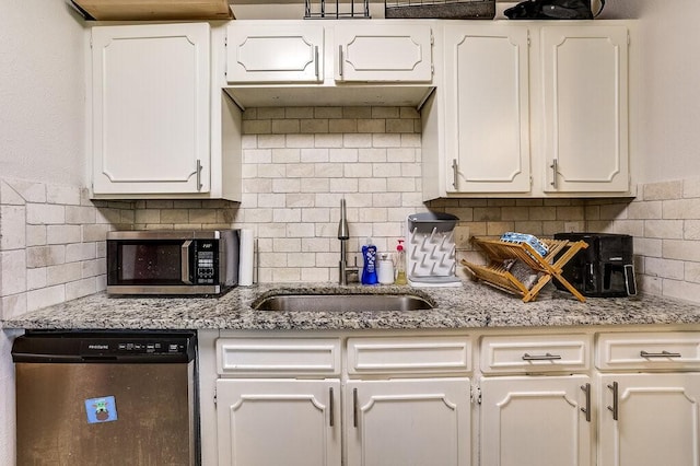 kitchen with white cabinets, appliances with stainless steel finishes, and a sink