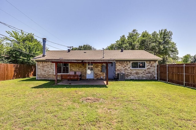 back of house with a yard, a fenced backyard, a patio, and central AC unit
