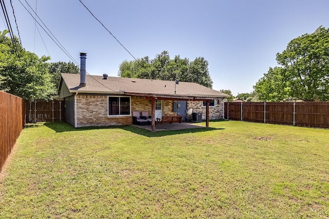 back of house with central AC unit, a lawn, a fenced backyard, a patio, and brick siding