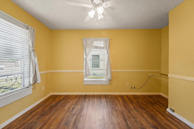 unfurnished room featuring ceiling fan, baseboards, wood finished floors, and a textured ceiling