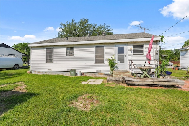 back of property with a yard