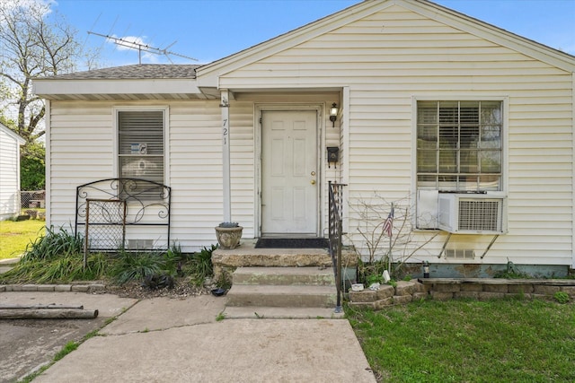 view of front of house featuring crawl space, a shingled roof, and cooling unit