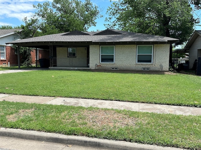 1928 Las Cruces Ln, Dallas, TX 75217 - view of front of house with a shingled roof, an attached carport, a porch, brick siding, and a front yard