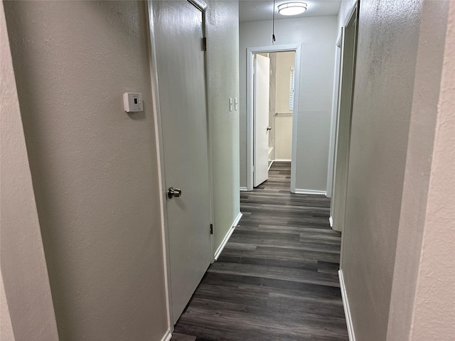 1928 Las Cruces Ln, Dallas, TX 75217 - hallway with dark wood-type flooring, a textured wall, and baseboards