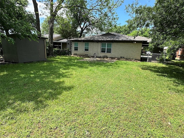 1928 Las Cruces Ln, Dallas, TX 75217 - rear view of property featuring a lawn, an outdoor structure, fence, and a shed
