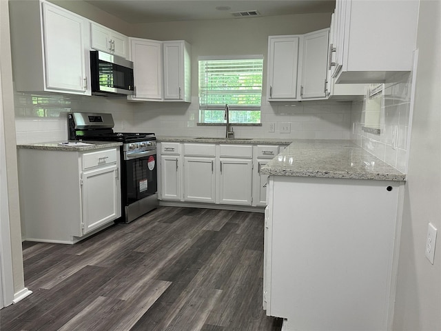 1928 Las Cruces Ln, Dallas, TX 75217 - kitchen featuring visible vents, appliances with stainless steel finishes, decorative backsplash, and a sink
