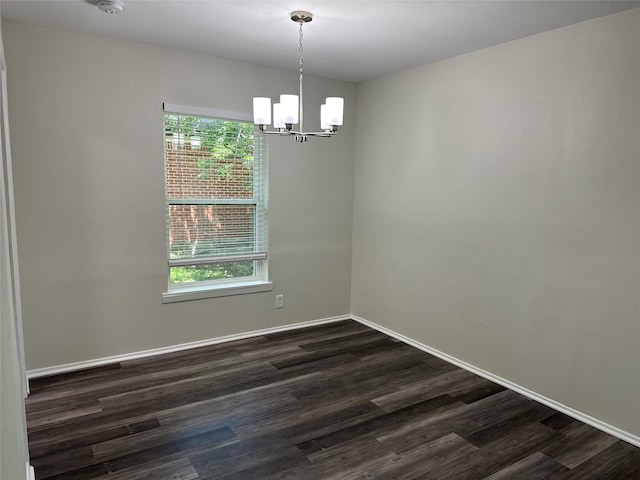 1928 Las Cruces Ln, Dallas, TX 75217 - spare room with a chandelier, baseboards, and dark wood-style floors