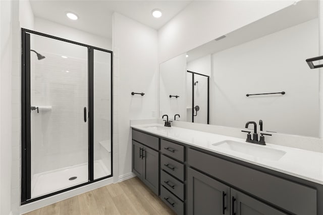 913 Janwood Dr, Plano, TX 75075 - full bathroom with a stall shower, wood finished floors, double vanity, and recessed lighting