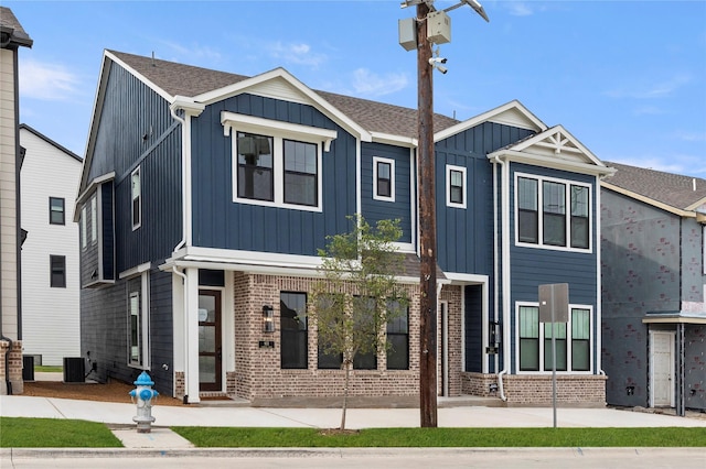 913 Janwood Dr, Plano, TX 75075 - view of front of house featuring board and batten siding, brick siding, and central air condition unit