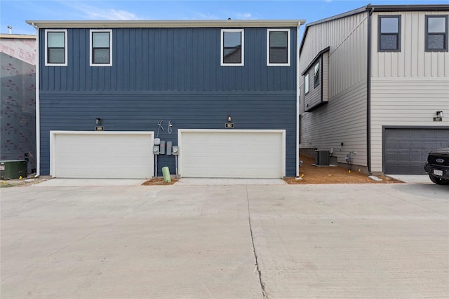 913 Janwood Dr, Plano, TX 75075 - view of front facade with central AC, board and batten siding, concrete driveway, and an attached garage