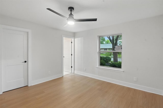 unfurnished bedroom with ceiling fan, light wood-style flooring, and baseboards