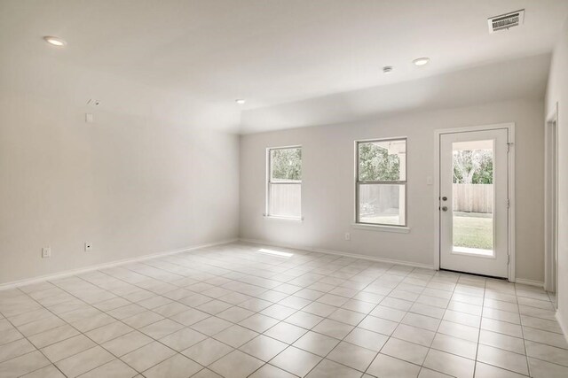 2235 Vance Dr, Forney, TX 75126 - unfurnished room featuring light tile patterned floors, a wealth of natural light, visible vents, and baseboards