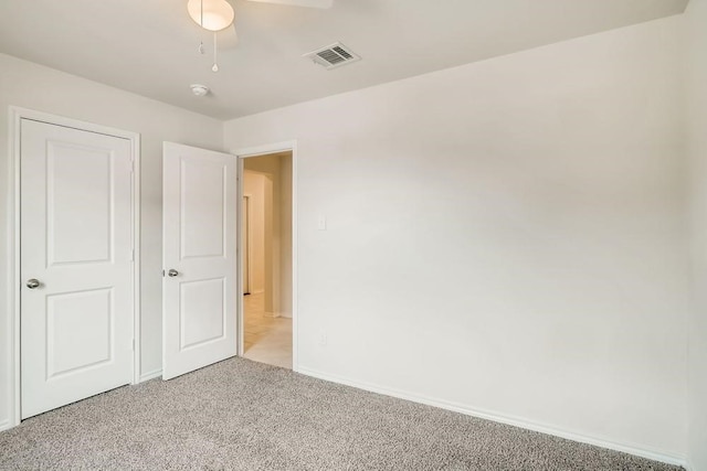 2235 Vance Dr, Forney, TX 75126 - unfurnished bedroom with light carpet, baseboards, visible vents, and a ceiling fan