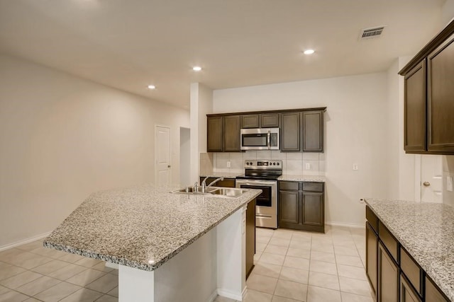 2235 Vance Dr, Forney, TX 75126 - kitchen with decorative backsplash, stainless steel appliances, a sink, and light tile patterned flooring