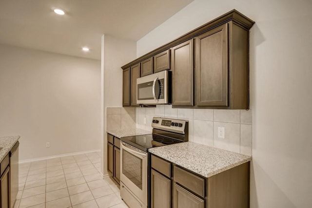 2235 Vance Dr, Forney, TX 75126 - kitchen with backsplash, light stone countertops, stainless steel appliances, and recessed lighting
