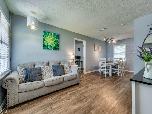 2631 Greenhurst Dr, Farmers Branch, TX 75234 - living room featuring wood finished floors, a textured ceiling, and baseboards