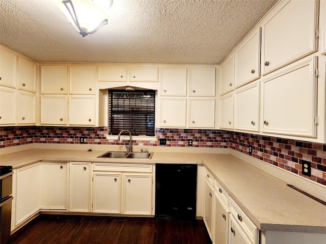kitchen with light countertops, a sink, a textured ceiling, and black dishwasher