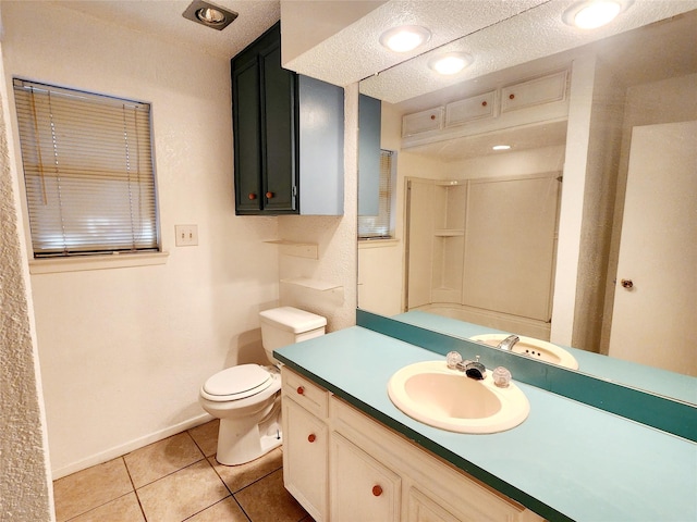 full bath featuring tile patterned flooring, toilet, vanity, baseboards, and a shower