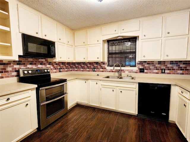 kitchen featuring a sink, a textured ceiling, black appliances, light countertops, and dark wood-style flooring