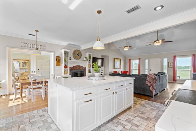 kitchen featuring open floor plan, white cabinets, a healthy amount of sunlight, and visible vents