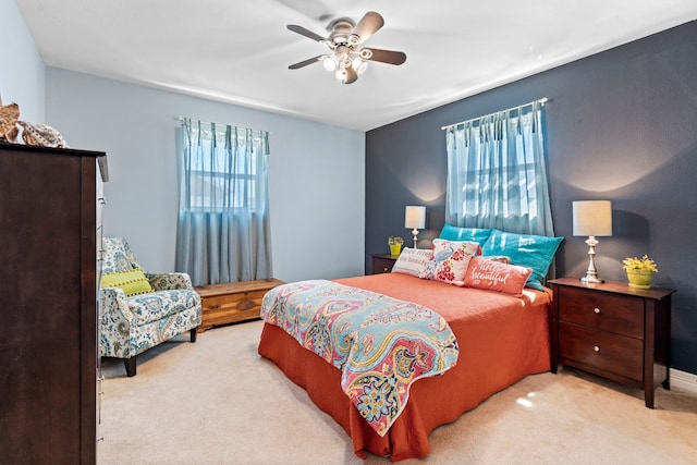 bedroom with carpet, ceiling fan, and multiple windows