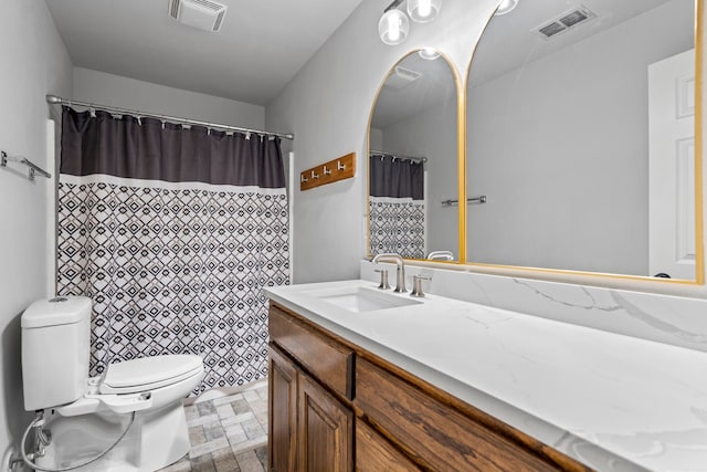 full bath with visible vents, stone finish floor, vanity, and toilet