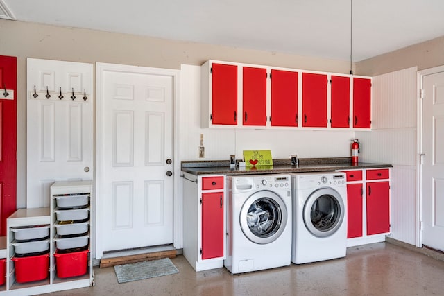 washroom featuring washing machine and dryer and cabinet space