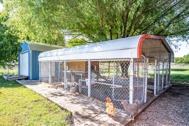 view of outdoor structure featuring an outbuilding and fence