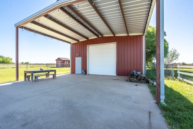 garage with a detached garage and fence