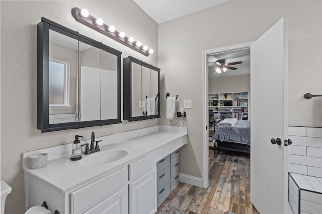 9112 Manassas Rdg, Mckinney, TX 75071 - bathroom featuring wood finished floors, ceiling fan, ensuite bath, vanity, and baseboards