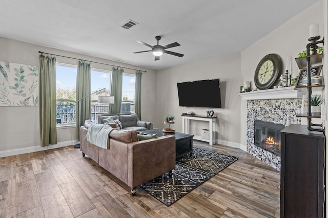 9112 Manassas Rdg, Mckinney, TX 75071 - living area featuring ceiling fan, wood finished floors, a fireplace, and baseboards