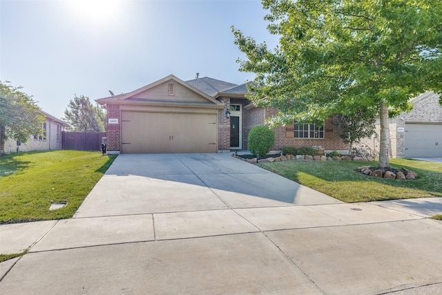 ranch-style home with driveway, fence, brick siding, an attached garage, and a front yard